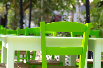 green chair at the glistening white table