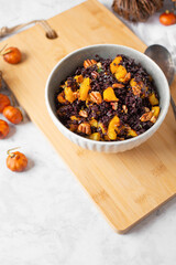 Bowl of Forbidden (Black) Rice and Acorn Squash in Fall Setting