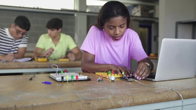 Black female teenager Student programming electronics in the technology course