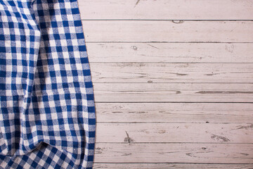 Wooden table with blue and white checkered tablecloth