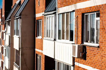 close-up window of a high-rise building with satellite dishes