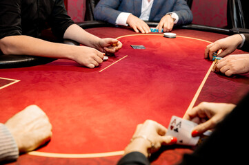 side view of men and women playing poker in a casino