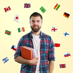 Person with  book and many different flags on light background. Studying of foreign languages