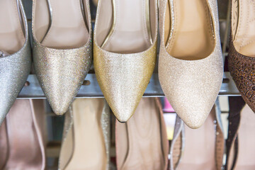 Woman's classic shoes on the shelves of the shoe shop. Beauty and fashion concept. Flat lay, top view