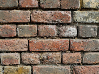 Old Brick wall weathered and damaged