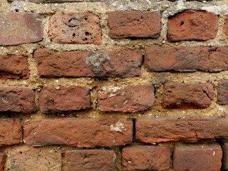 Old Brick wall weathered and damaged