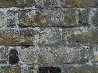Old Brick wall weathered and damaged