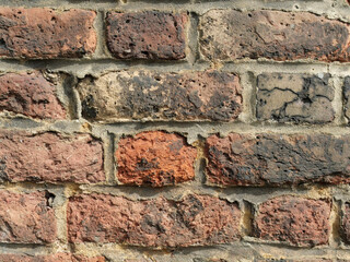 Old Brick wall weathered and damaged