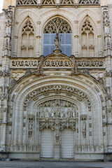 Fototapeta na wymiar Gothic style details of facade of Royal Monastery of Brou at French town of Bourg-en-Bresse, department of Ain, Auvergne-Rhone-Alpes region