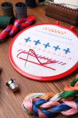 Set of embroidery equipment on wooden table