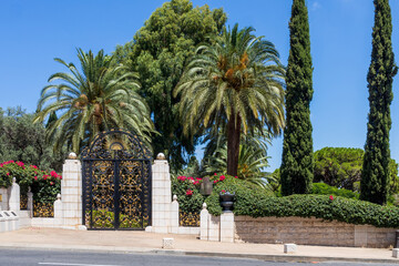 Fototapeta na wymiar Haifa, Israel, July 12, 2022 : The decorative metal gate at the entrance to the middle terrace of the Bahai Garden, located on Mount Carmel in the city of Haifa, in northern Israel