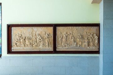 HAIFA, ISRAEL. June 26, 2022: Muhraka monastery of the Carmelite on the Carmel mount . Bas-relief depicting the priests of Baal at the altar and prophet Elijah