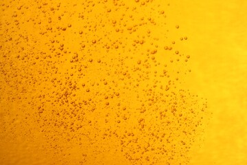 Tasty beer with bubbles as background, closeup