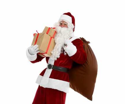Santa Claus with sack and gifts on white background
