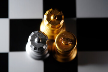 Close up of golden and silver chess piece