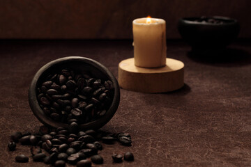 international coffee day, traditional Colombian drink, roasted coffee beans, a candle is lit in closeup