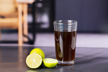 granulated panela and agua de panela or sugar cane sweets and lemon in the kitchen, typical food of Colombia