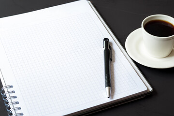 international coffee day, traditional colombian drink, coffee mug,empty notebook with coffee on black table, top view