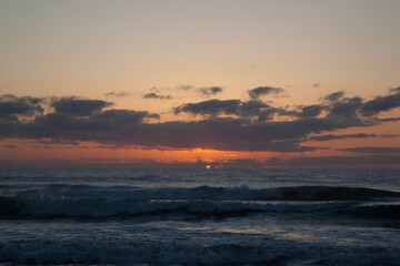 Sunrise over the ocean waves