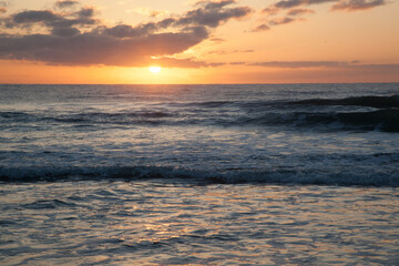 Sunrise over the ocean waves