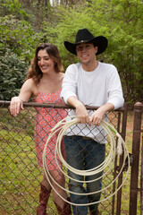 Cowboy couple with him holding a lasso