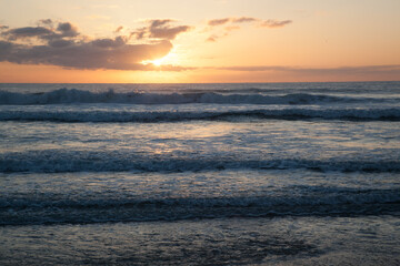 Sunrise over the ocean waves