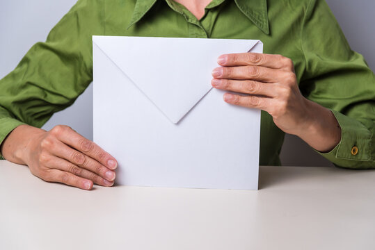 Hands Holding A Large Paper Envelope