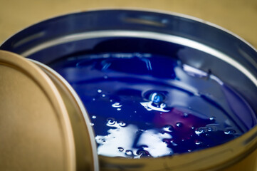 A can of blue polygraph offset paint for the printing press. Special UV ink for printing. Cyan...