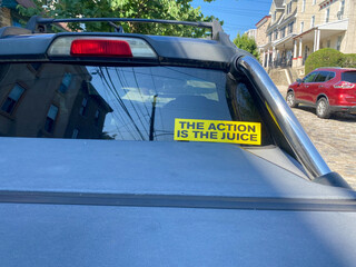 Message on a car window that says "The Action is the Juice"