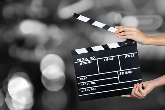 Hands Holding a Film Slate Directing a Movie Scene. Cinematography film-making concept on background