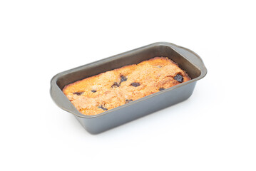 piece of craft cornbread home made Johnny bread made of corn flour and fig pieces in a metallic bakery mold isolated on a white background