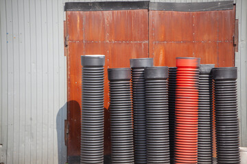 Plastic pipes for sewerage on street. Ribbed pipes in stock. Sewerage system.