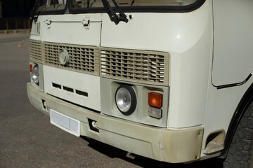 White bus in parking lot. Bus in city. Parking transport. Old car.