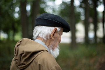 Gray haired elderly man. Russian old man. Retired in Russia. Man walks down street.