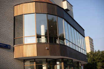 Glazed balcony in building. Modern building of theater. Large windows at entrance to office building.