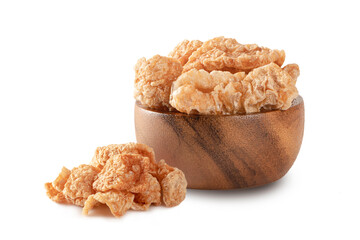 Pork rind in wooden bowl on white background.