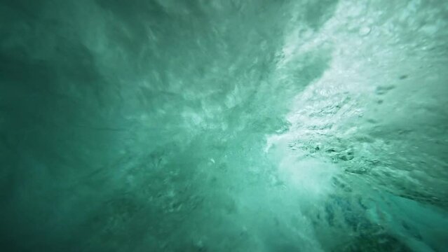 Underwater view of tube wave breaking over coral reef with spinning vortex. powerful nature, strong wave. slow motion 4k.