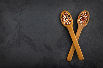Mix of red, white and brown quinoa in two spoons - Chenopodium quinoa