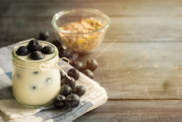 Obraz na płótnie Canvas yogurt with fresh blueberry on a wooden background. healthy cereal morning breakfast,oat