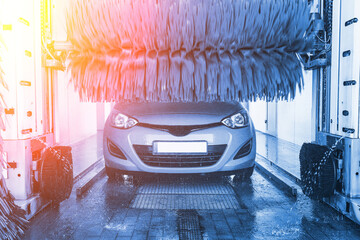 Car wash background automatic carwash. Brush washer clean blue auto car on automatic carwash...