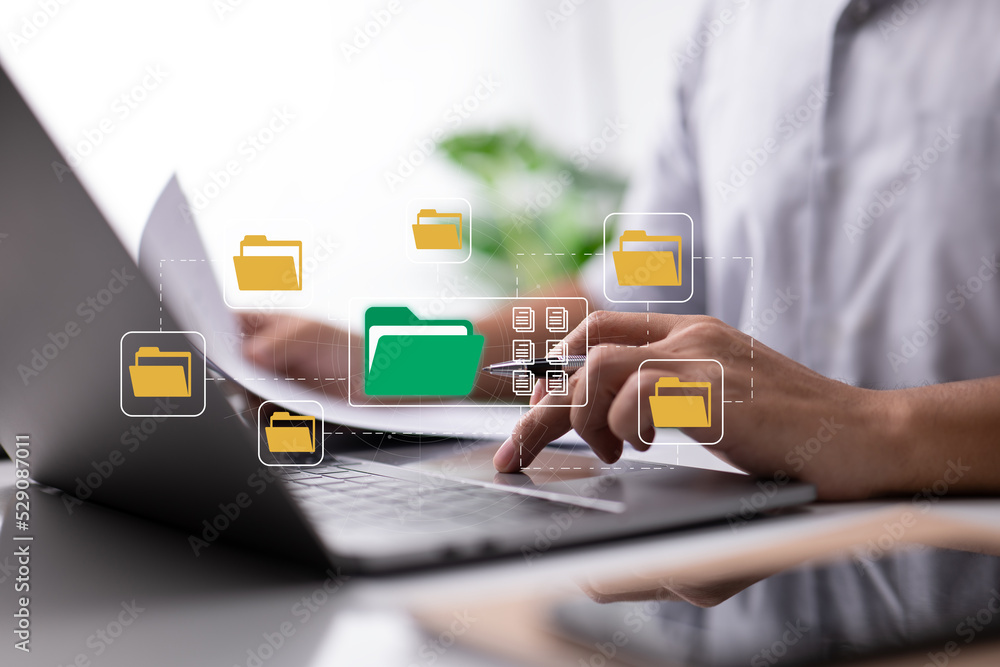 Aufkleber paperless office idea based on electronic documents. a businessman types on a laptop keyboard while 