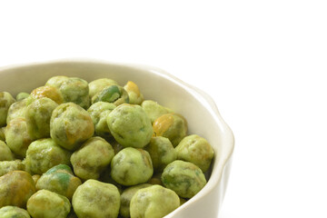 Crispy Green Peas Coated with Wasabi in porcelain cup isolated on white background.