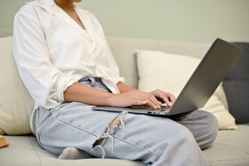 Naklejka premium A female or businesswoman remote working at home, work from home, using laptop