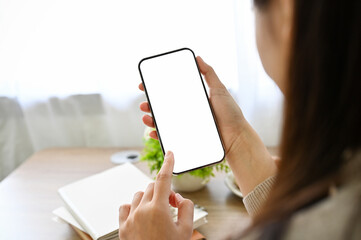 close-up, Asian female using her smartphone. a woman holding a mobile phone white screen mockup.