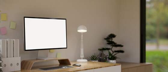 Minimal cozy home office interior design with white screen computer mockup and decor on wood table