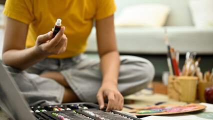 A female painter choosing an acrylic color for her art paint. cropped shot