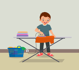 Fototapeta na wymiar cute little boy ironing clothes doing daily chores housework activity 