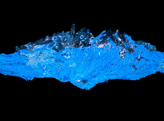 Blue Water waves and water splash. black background and copy space above and below