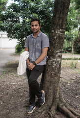South asian young boy fashion model posing in outdoor park