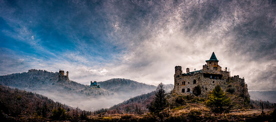 Fototapeta 3D rendering of a lonely abandoned castle in the mountains with dramatic sky background obraz